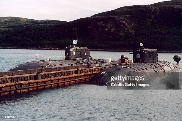 Russian submarines Kostroma L and Pskov R are moored at piers July 26 2003 in the Barents Sea near Vedyaevo, Russia. A Russian K-159 nuclear...