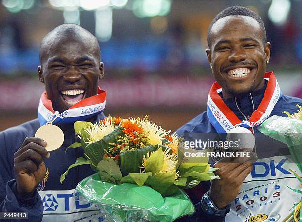 Gold medalist John Capel and compatriot silver medalist Darvis Patton celebrate on the podium after the 200m finals 29 August 2003 during the 9th...