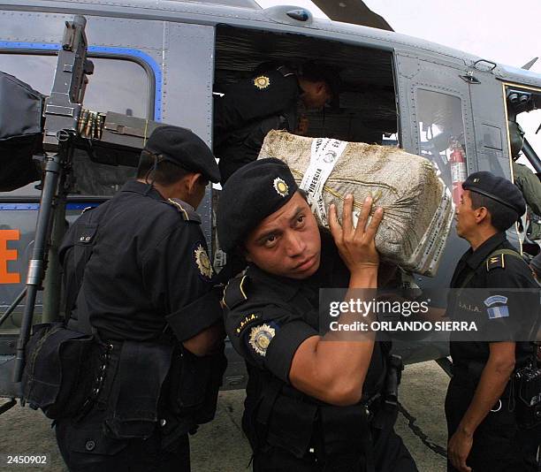 Members of the National Police Antidrugs Squad download 364 Kg of cocaine from a Guatemalan Air Force helicopter, seized from two motorboats in...