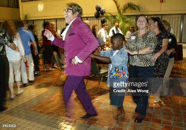 Impersonator Michael Levick, who portrays Austin Powers, leads a snake dance during a private birthday party at a local hotel August 30, 2003 in...