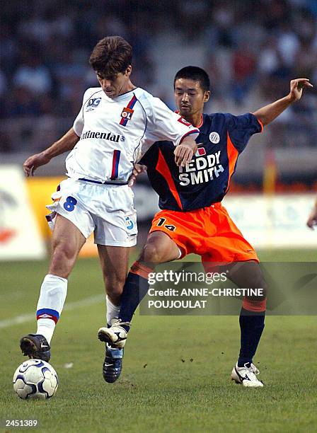 Montpellier Herault club's midfielder, Japanese Nozomi Hiroyama fights for the ball with Lyon's midfielder, Brazil's Juninho Pernambucano during...
