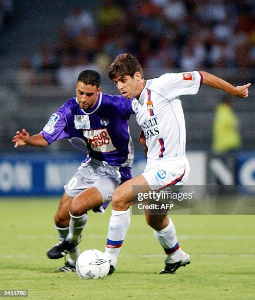 Lyon's Brazilian midfielder Pernambucano Juninho vies with Toulouse's midfielder Nabil Taider, during the French first league soccer match...