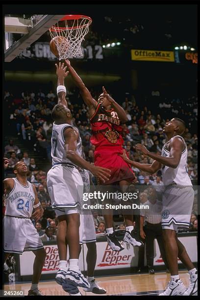 Guard Ed Gray of the Atlanta Hawks goes up against guard Dennis Scott of the Dallas Mavericks during a game at Reunion Arena in Dallas, Texas. The...