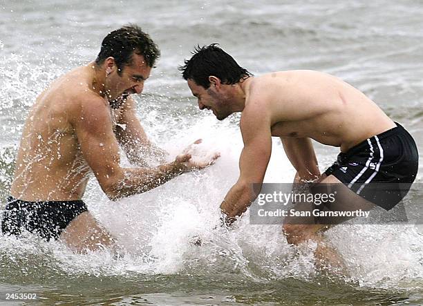 Collingwood players Anthony Rocca and Alan Didak splash each other during a Collingwood Magpies training session at St Kilda beach September 2, 2003...