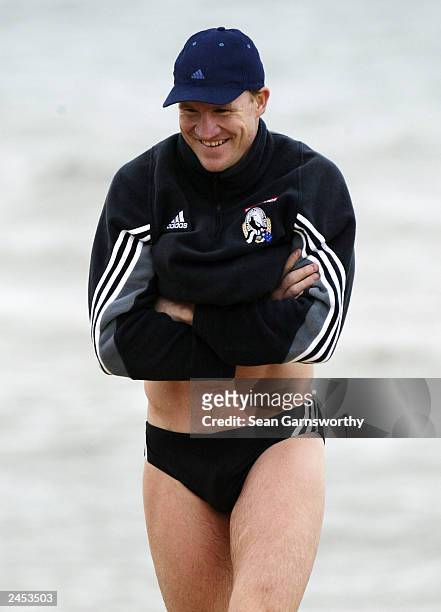 Collingwood captain Nathan Buckley recovers during a Collingwood Magpies training session at St Kilda beach September 2, 2003 in Melbourne,...