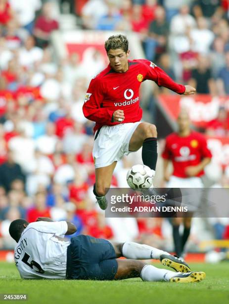 Manchester United's Cristiano Ronaldo jumps over a tackle from Bruno N'Gotty of Bolton Wanderers during the first Premiership match of the season at...