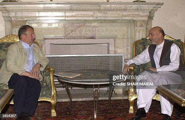 Afghan President Hamid Karzai meets with Belgian Defence Minister Andre Flahaut at the presidential palace in Kabul, 26 August 2003. Flahaut and...
