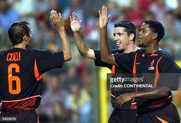 Dutch Roy Makaay celebrates with his teammates Patrick Kluivert and Phillip Cocu after scoring 1-1 during the friendly match Belgium vs the...
