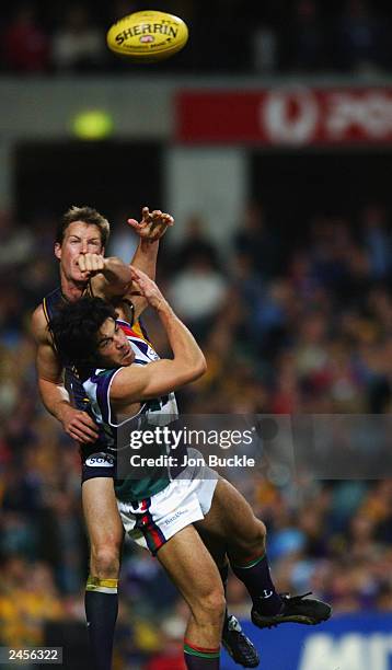 Kasey Green of the Eagles spoils the ball as Paul Medhurst of the Dockers attempts to mark during the round 22 AFL match between the West Coast...