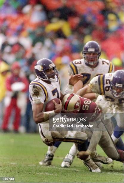 Defensive end Chris Doleman of the San Francisco 49ers sacks quarterback Randall Cunningham of the Minnesota Vikings during a game at 3Com Park in...