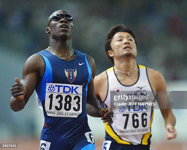 John Capel of the US wins the men's 200m semi-final, ahead ofShingo Suetsugu of Japan, who won the bronze 29 August 2003, during the 9th IAAF World...