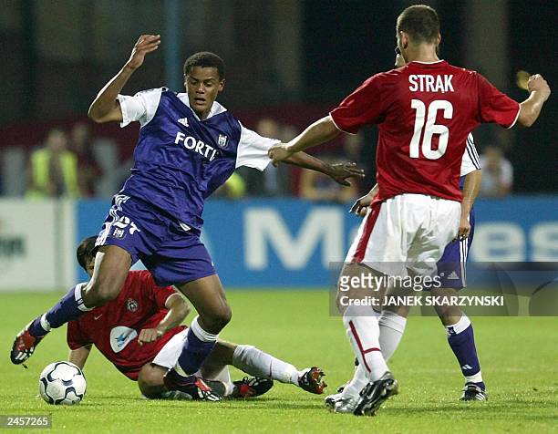 Vincent Kompany from Anderlecht fights for ball with Pawel Strak and Miroslaw Szymkowiak from Wisla Krakow during their Champion League preliminary...