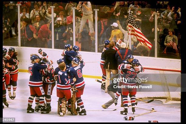 The USA hockey team celebrates winning the gold medal after defeating Finland 4-2 in the gold medal match during the 1980 Winter Olympic Games on...