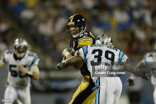 Jay Riemersma of the Pittsburgh Steelers braces for a hit from Damien Richardson of the Carolina Panthers on August 29, 2003 at Ericsson Stadium in...