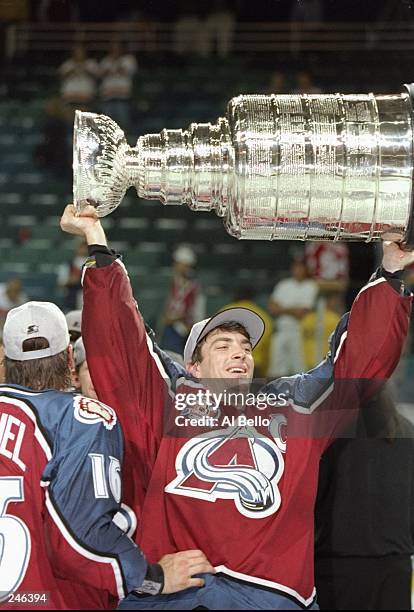 Joe Sakic of the Colorado Avalanche holds up the Stanley Cup Trophy after the Avalanche 1-0 win over the Florida Panthers in the 1996 NHL Stanley Cup...