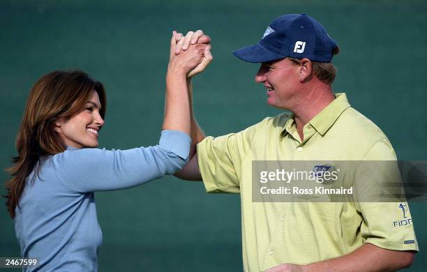 Cindy Crawford and Erniie Els of South Africa celebrate winning the Double Eagle Challenge after the third round of the Omega European Masters at...