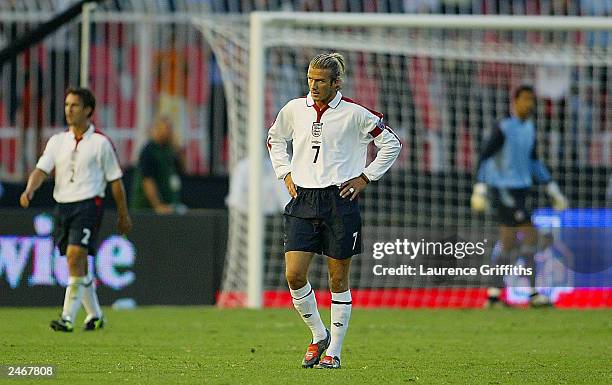 David Beckham of England looks dejected as Macedonia celebrate the opening goal during the Euro 2004 qualifying match between Macedonia and England...