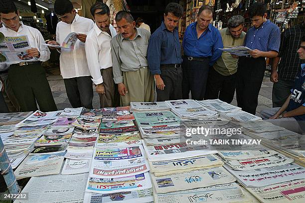 News is a precious item in Iraq especially after the war. Men gather around local newspapers in order to view the front pages, 04 September 2003....