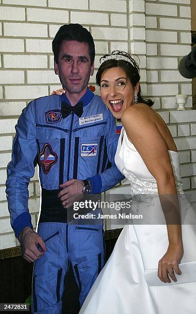 Ekaterina Dmitriev, the bride of Russian cosmonaut Yuri Malenchenko, poses with a life size cut out of her new husband at a press conference in...