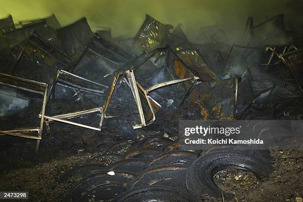 Smoldering debris is seen smoldering at a Bridgestone Corp tire plant at the Bridgestone Tochigi factory in Kuroiso on September 9. 2003 in...