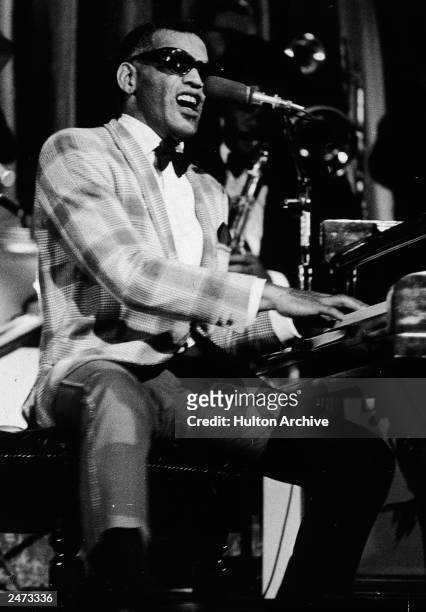 Musician Ray Charles performing at a piano, c. 1960.