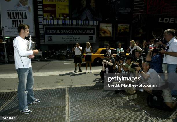 Open men's singles champion Andy Roddick poses for photographers September 8, 2003 at Time Square in New York City.