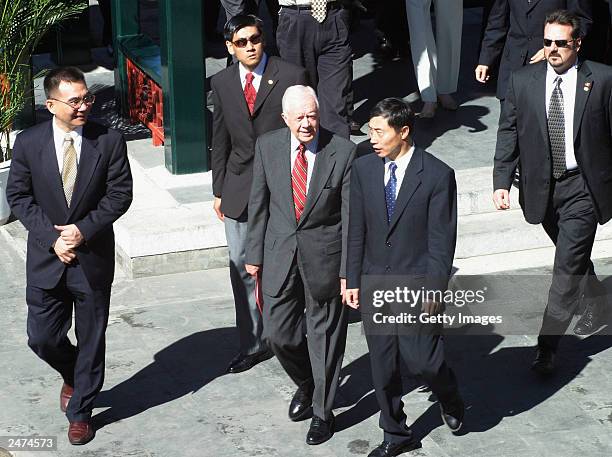 Former U.S. President Jimmy Carter leaves Peking Univesity after giving a talk about democracy on September 9, 2003 in Beijing, China. Carter's...