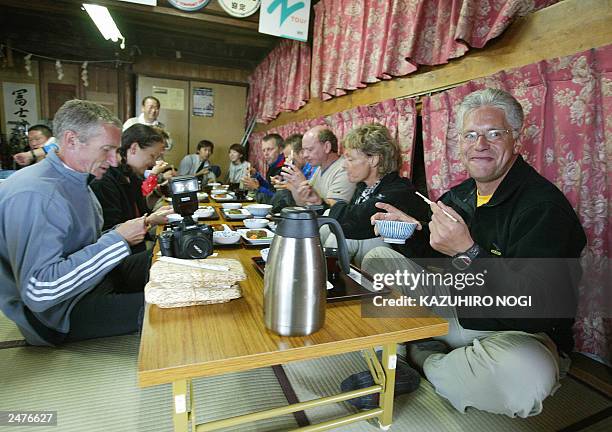 Hartwig Gauder , former German Olympic champion, and his supporters enjoy dinner in a mountain house at Mt. Fuji, Yamanashi Prefecture, 18 July 2003....