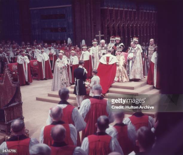 The Duke of Edinburgh pays homage to his wife, the newly crowned Queen Elizabeth II, during her coronation ceremony, Westminster Abbey, London,...