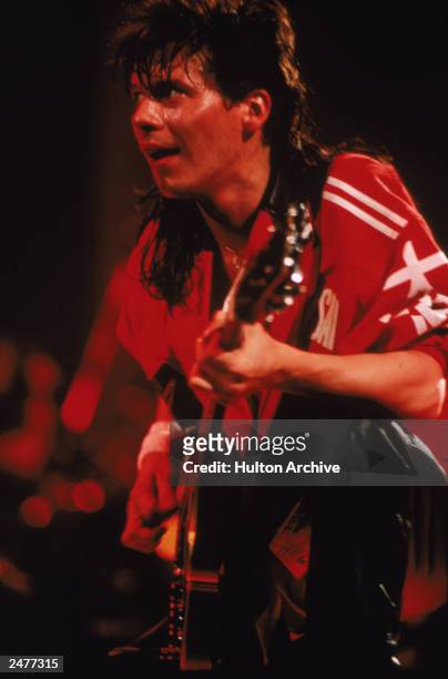 Guitarist Andy Taylor of the British pop group Duran Duran performing on stage during a concert, 1984.