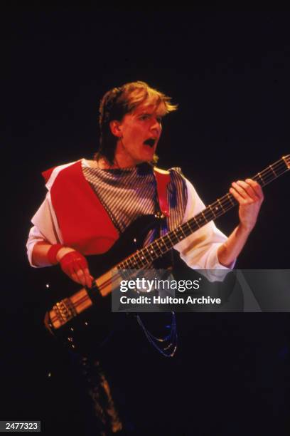 Bassist John Taylor of the British pop group Duran Duran performing on stage during a concert, 1984.