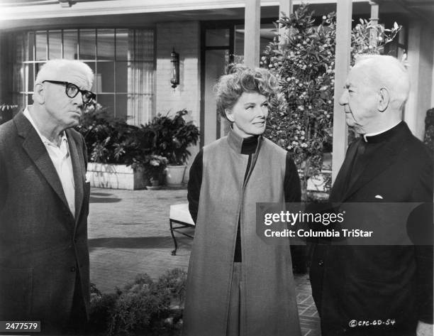 American actors Spencer Tracy and Katharine Hepburn look at South African actor Cecil Kellaway in a still from the film, 'Guess Who's Coming To...