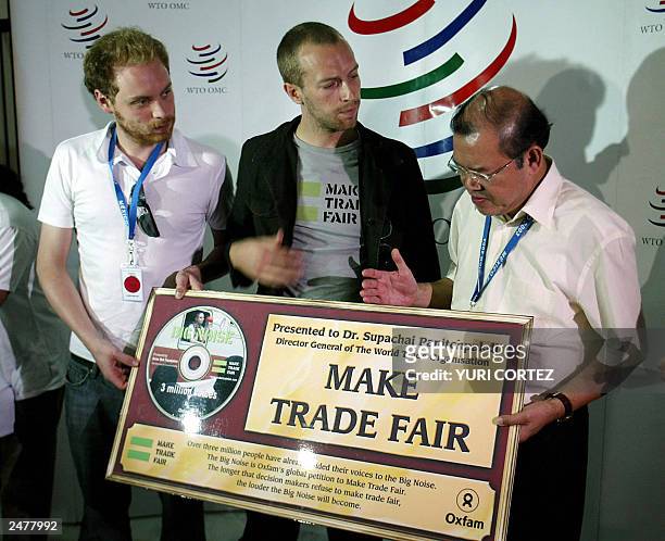 British rock group Coldplay's singer Chris Martin and guitarist John Buckland, show Supachai Panitchpakdi president of the World Trade Organization ,...