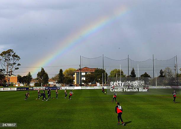 Matthew Lloyd of Essendon in action under a rainbow during the Essendon Bombers AFL training session at Windy Hill on September 10, 2003 in...
