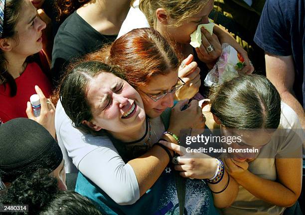 Mourners attend the funeral of Israeli Nava and David Applebaum September 10, 2003 in Jerusalem. Both father and daughter were killed in an explosion...