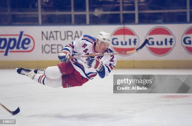 Defensive player Brian Leetch of the New York Rangers is sent flying through the air after being tripped up with a hockey stick in a game against the...