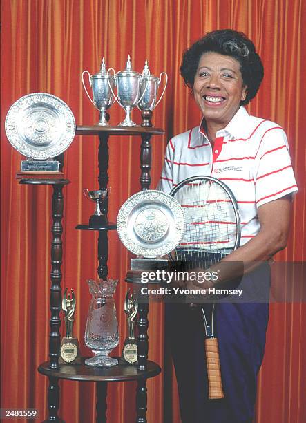 Tennis legend Althea Gibson poses for a portrait at her home surrounded by her trophies June 12, 1987 in East Orange, NJ.