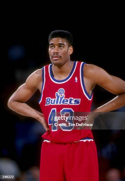 Center Pervis Ellison of the Washington Bullets stands on the court during a game against the Denver Nuggets at the McNichols Sports Arena in Denver,...