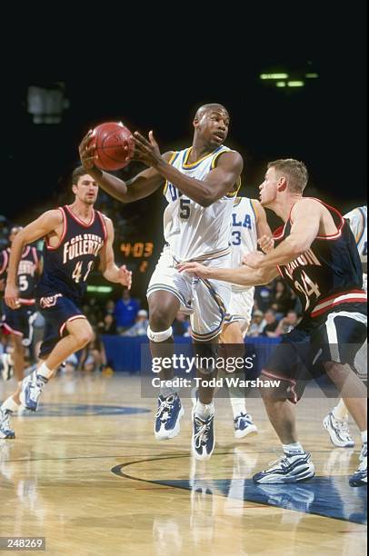 Baron Davis of the UCLA Bruins dribbles down the court during a game against the Cal State Fullerton Titans at the Pauley Pavillion in Westwood,...