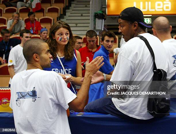 French Tony Parker speaks with a friend and his father Tony Parker senior , 07 September 2003 at the Coop Arena of Lulea after the Group A match...