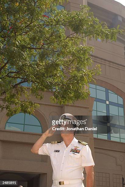 Navy Captain David Johnson, who works at the Pentagon and was there the morning of the terrorist attacks on September 11 salutes a flag that flew...