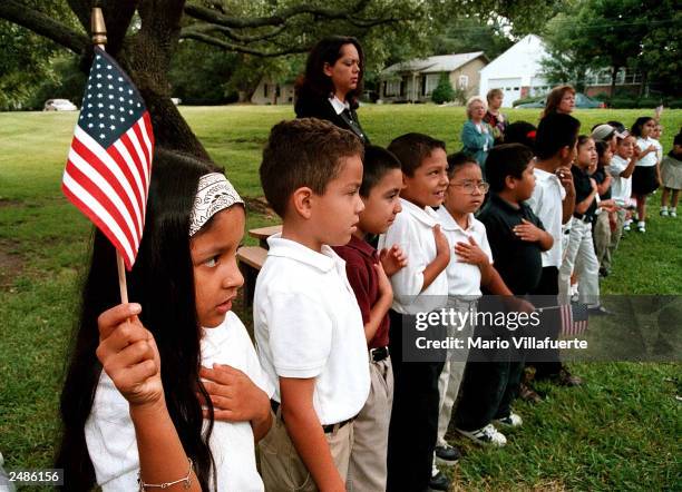 Class of Hispanic students recites the Pledge of Allegiance during a September 11 memorial service at Birdwell Elementary School September 11, 2003...