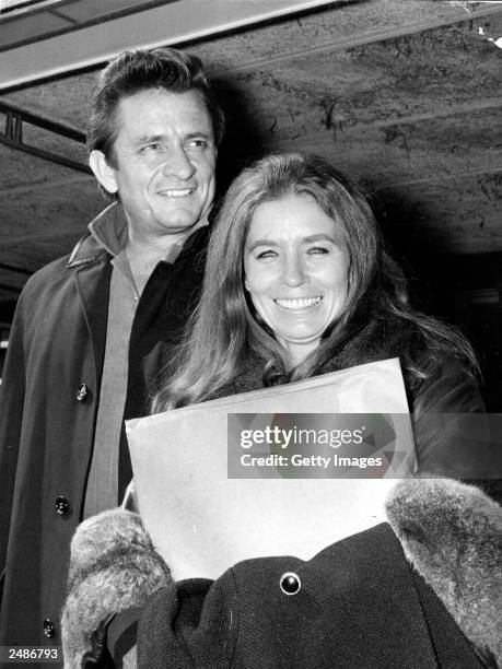 American country singer and songwriter Johnny Cash and his wife June Carter Cash of the Carter Family group arrive May 1, 1968 at London Airport in...