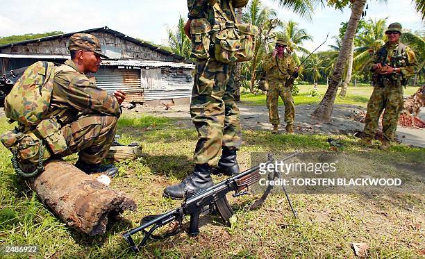 Tongan soldiers from the Australian-led intervention force secure the supply landing site at Red Beach near Honiara in the Solomon Islands, 29 July...