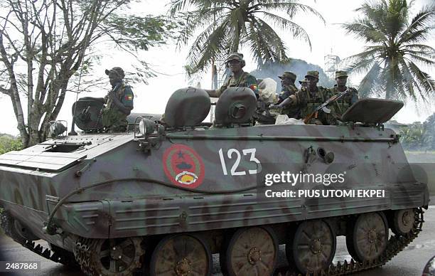 An armoured car leads the way from Roberts International Airport, in Monrovia 09 September 2003 as one-batallion Guinea-Bissau soldiers heads for...