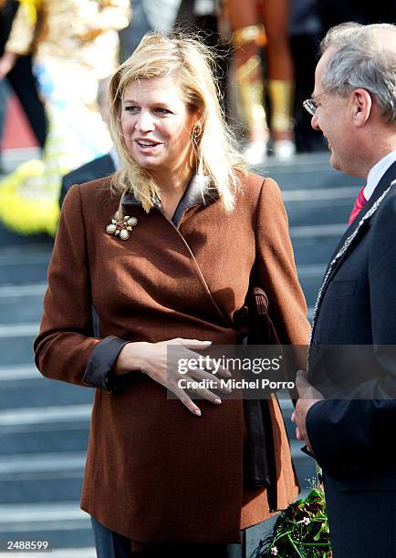 Crown Princess Maxima of Holland holds her hand on her stomach after officially opening the new FMO Development Bank building September 12, 2003 in...