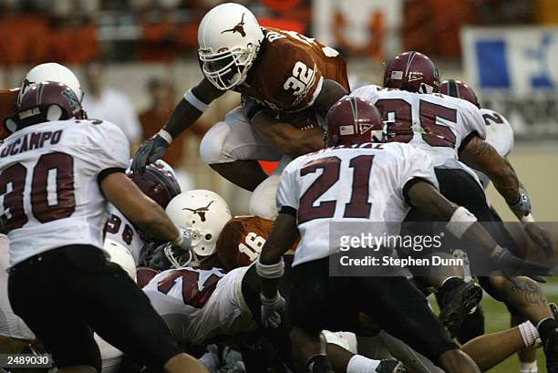 Running back Cedric Benson of the University of Texas at Austin Longhorns leaps over the New Mexico State University Aggies during the game Texas...