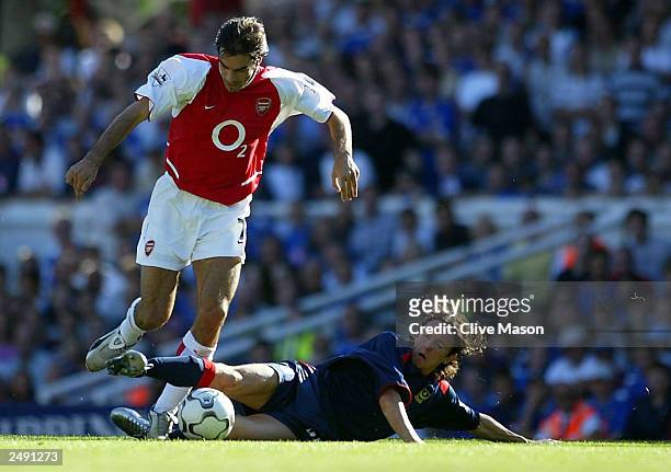 Alexie Smertin of Portsmouth tackles Robert Pires of Arsenal during the FA Barclaycard Premiership match between Arsenal and Portsmouth at Highbury...
