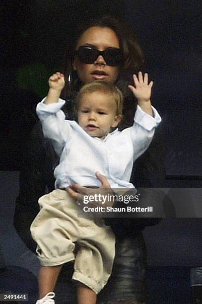 Victoria Beckham and son Romeo watch David Beckham play in the Spanish Primera Liga match between Real Madrid and Valladolid at the Santiago Bernabeu...