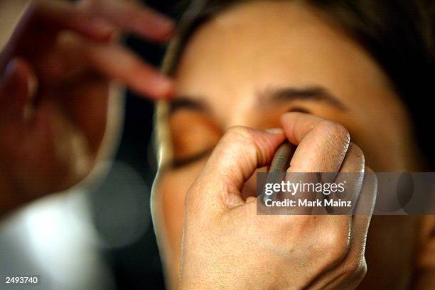 Model prepares backstage for the Alice Roi Spring/Summer 2004 Fashion Show at Maurice Villency during the 7th on Sixth Mercedes-Benz New York Fashion...